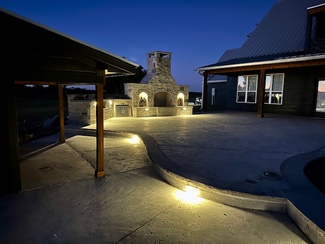 Modern pool with concrete decking and privacy fencing